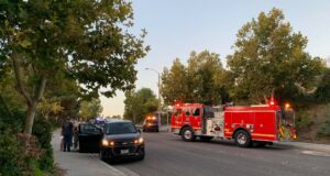 A fire engine and a car at the scene of the Santa Clarita motorcycle crash.