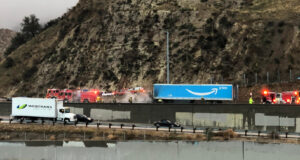 Amozon big rig on fire on 5 freeway with firefighters surrounding