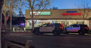 Two Santa Clarita Sheriff squad cars parked in front of the Bonanza Liquor Store knife