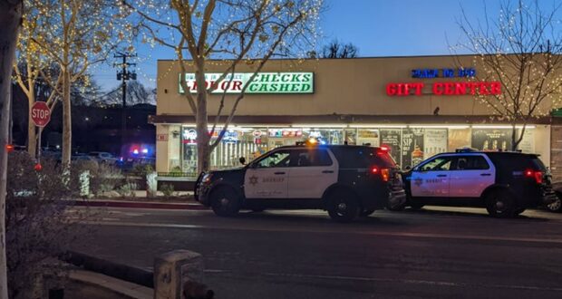 Two Santa Clarita Sheriff squad cars parked in front of the Bonanza Liquor Store knife