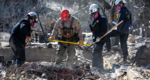 Los Angeles County Sheriff’s deputy Orlando Martinez, center, and FEMA Urban Search & Rescue officers search neighborhood gutted in Eaton Fire in Altadena, CA, Wednesday, January 15, 2025. (Irfan Khan / Irfan Khan)