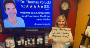 Smiling woman holding hand written sign “Had Pharmacist Cancel My Monthly Migraine Shot” at Santa Clarita chiropractor Dr. Thomas Polucki DC, featured in AP-distributed press release for breakthrough migraine and pain relief solution.