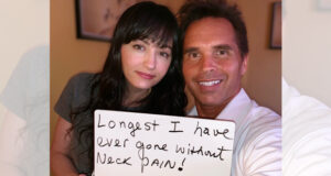 Smiling woman holding hand written sign “Longest I Have Ever Gone Without Neck Pain” at Santa Clarita gentle chiropractic care with Dr. Thomas Polucki DC